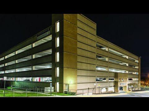 Reston Hospital Center’s parking structure from outside at night, shining brightly with LED parking garage lighting.